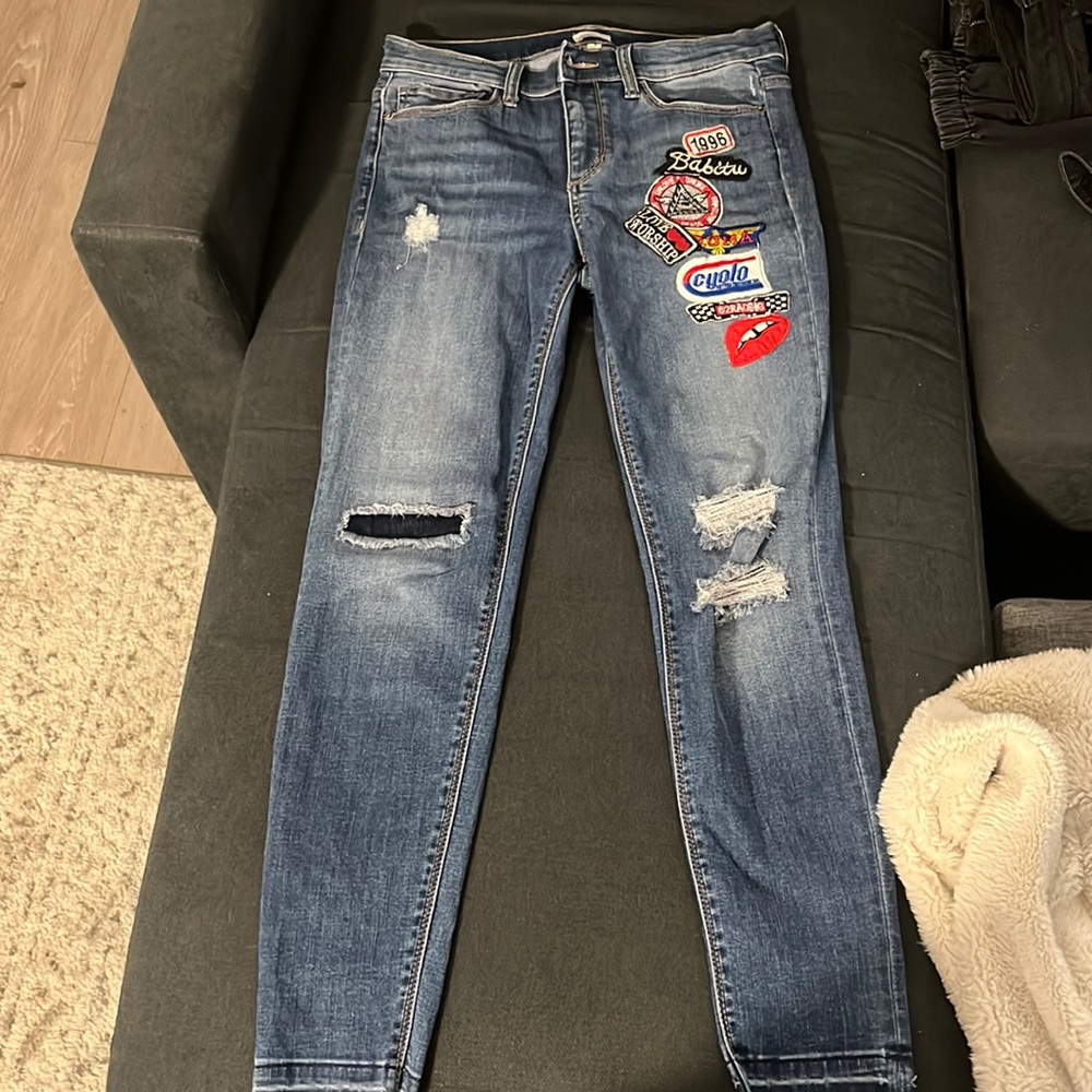 Sneak peek blue skinny jeans. Adorable patches on front